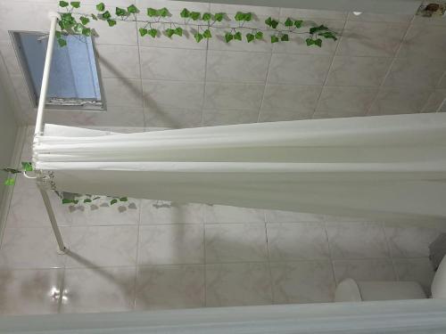 uma banheira branca na casa de banho com uma janela em CasaLeon em Mejillones