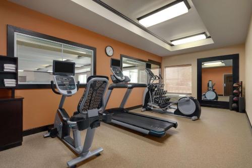 a gym with two exercise bikes and a treadmill at Homewood Suites by Hilton Fort Smith in Massard