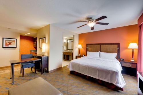 a hotel room with a bed and a desk at Homewood Suites by Hilton Fort Worth Medical Center in Fort Worth