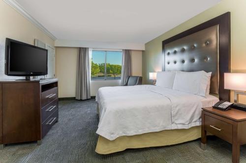 a hotel room with a bed and a flat screen tv at Homewood Suites by Hilton Ft. Worth-North at Fossil Creek in Fort Worth