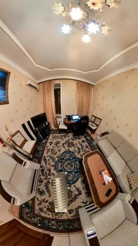 an overhead view of a living room with a couch and chairs at Fountain Square Apartment in Baku