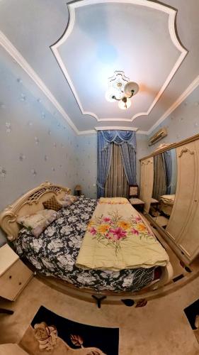 a bedroom with a bed and a ceiling at Fountain Square Apartment in Baku