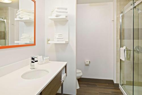 a white bathroom with a sink and a toilet at Hampton Inn & Suites Spokane Valley in Spokane Valley