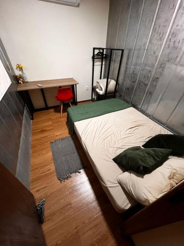 Katil atau katil-katil dalam bilik di Casa Container Camisão