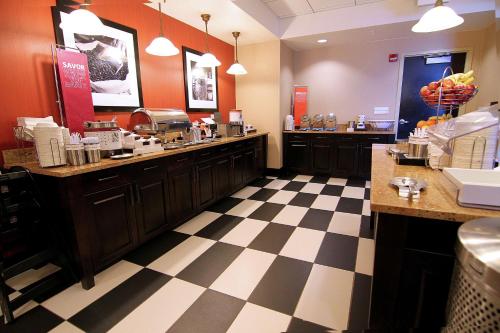 a restaurant kitchen with a checkered floor at Hampton Inn & Suites Grand Forks in Grand Forks