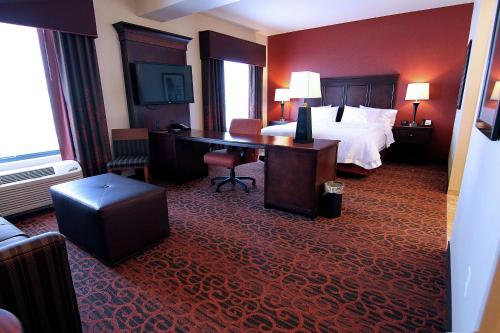 a hotel room with a bed and a desk at Hampton Inn & Suites Grand Forks in Grand Forks