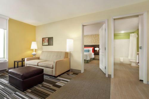 a hotel room with a couch and a bed at Home2 Suites by Hilton Biloxi/North/D'Iberville in Biloxi