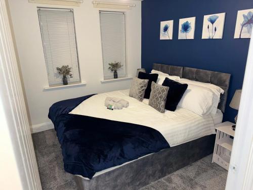 a bedroom with a bed with a teddy bear on it at Modern 2 Bed Apartment - Blue Madison in Aldershot