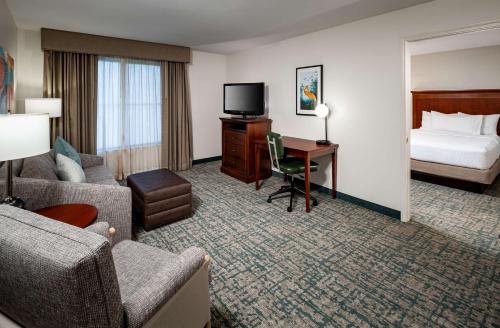a hotel room with a bed and a desk at Homewood Suites by Hilton Gainesville in Gainesville