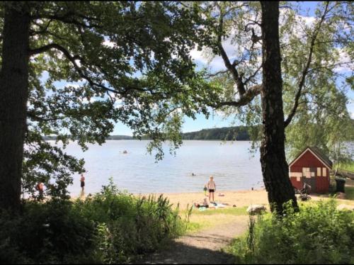 a beach with people swimming in the water at Villa Tilda in Mathildedal