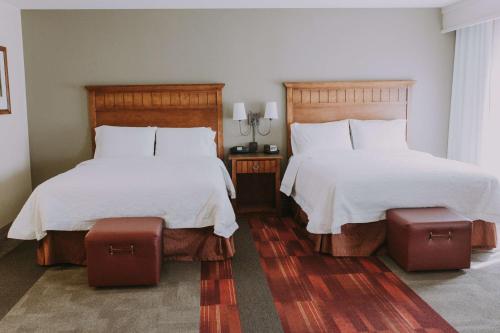 a bedroom with two beds with white sheets at Hampton Inn & Suites Green River in Green River