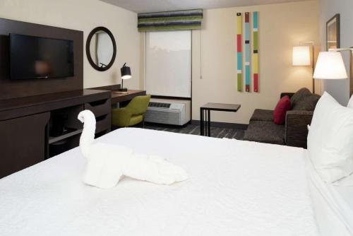 a hotel room with a swan on a bed at Hampton Inn Greensboro Airport in Greensboro