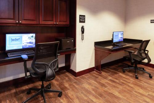 an office with a desk with a computer and two chairs at Hampton Inn Greensboro Airport in Greensboro