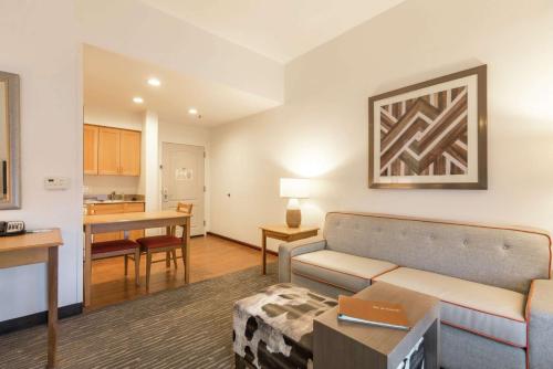 a living room with a couch and a kitchen at Homewood Suites by Hilton at Carolina Point - Greenville in Greenville