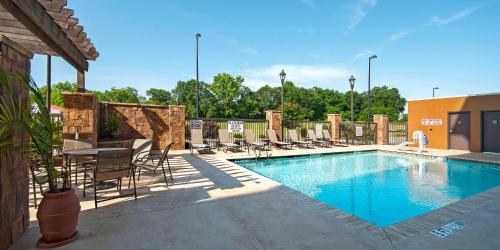 a large swimming pool with chairs and a table at Hampton Inn & Suites Seneca-Clemson Area in Seneca