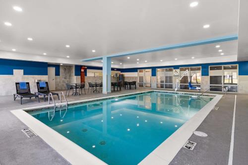 a large swimming pool in a building with a pool at Hampton Inn & Suites Schererville in Schererville