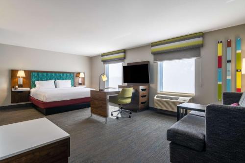 a hotel room with a bed and a desk at Hampton Inn & Suites Schererville in Schererville