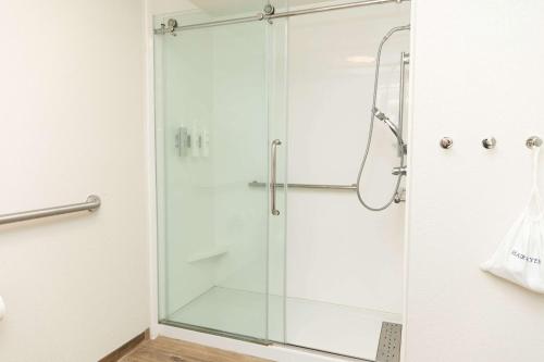 a shower with a glass door in a bathroom at Hampton Inn Hammond in Hammond