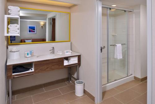 a bathroom with a sink and a shower at Hampton Inn Henderson in Henderson