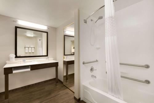 a bathroom with a tub and a sink and a shower at Hampton Inn & Suites Hershey in Hershey