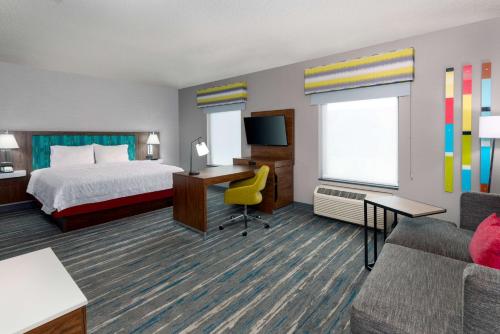 a hotel room with a bed and a desk at Hampton Inn and Suites Hartford/Farmington in Farmington