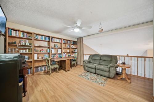 a living room with a chair and book shelves at 2-Bedroom Loft Suite 14 minutes from Airport and Mall of America in Inver Grove Heights