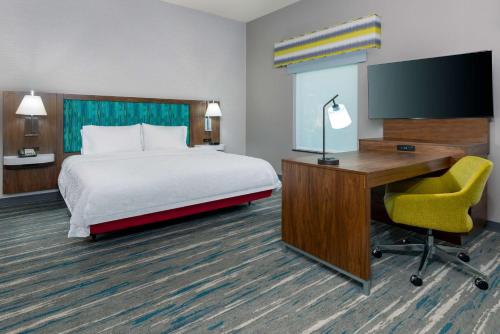 a hotel room with a bed and a desk and a computer at Hampton Inn and Suites Hartford/Farmington in Farmington
