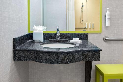 a bathroom with a sink in a hotel room at Hampton Inn and Suites Hartford/Farmington in Farmington