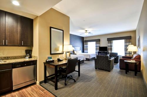 a hotel room with a bed and a desk and a room at Homewood Suites by Hilton Hartford / Southington CT in Southington