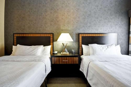 a hotel room with two beds and a table with a lamp at Homewood Suites by Hilton Hartford / Southington CT in Southington