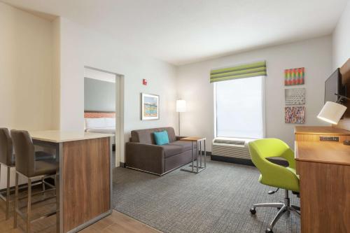 a hotel room with a desk and a chair at Hampton Inn & Suites Houston-Cypress Station in Westfield