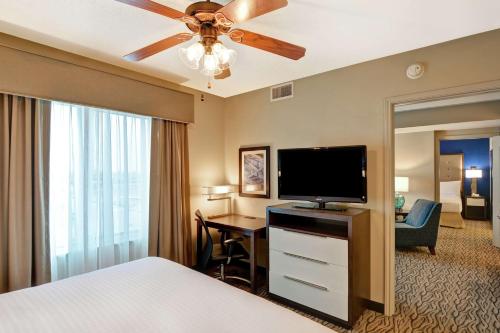 a hotel room with a bed and a flat screen tv at Homewood Suites by Hilton Houston Near the Galleria in Houston