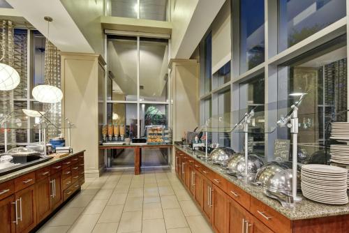 a large kitchen with a counter with dishes on it at Homewood Suites by Hilton Houston Near the Galleria in Houston