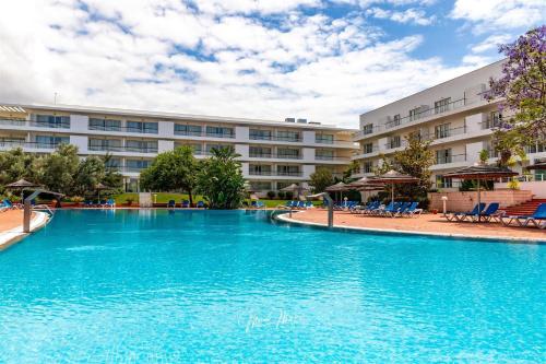 a large swimming pool in front of a building at Lucky Star Marina Apartment, with Pool in Lagos