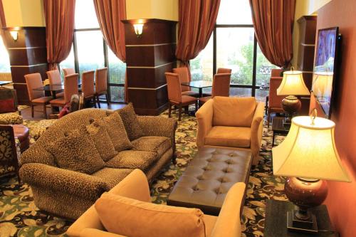 a living room with a couch and chairs and windows at Hampton Inn and Suites Houston-Katy in Katy
