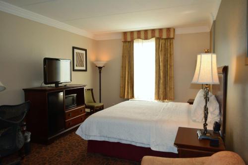 a hotel room with a bed and a television at Hampton Inn and Suites Houston-Katy in Katy