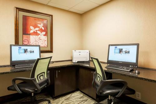 a conference room with two computers on a desk at Hampton Inn Nanuet in Nanuet