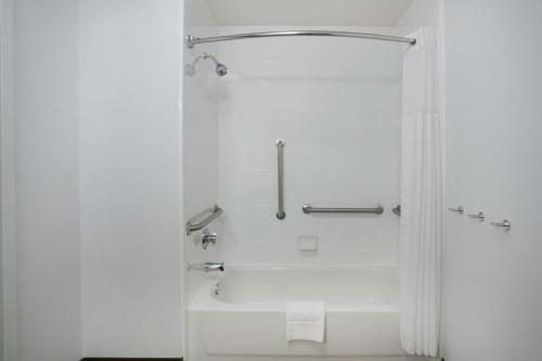 a white bathroom with a tub and a shower at Hampton Inn Huntsville-Madison in Madison