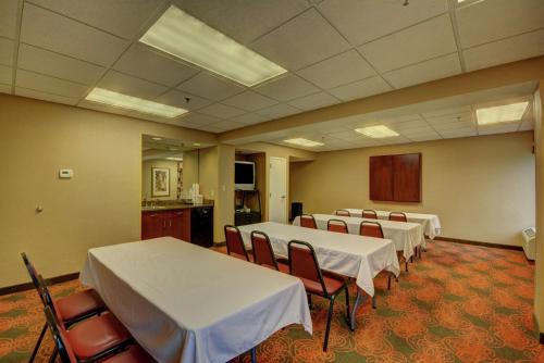 a room with several tables and chairs with white table cloth at Hampton Inn by Hilton Indianapolis-South in Southport
