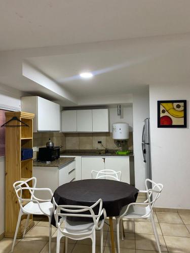 a kitchen with a table and chairs in a kitchen at temporarios en rosario in Rosario
