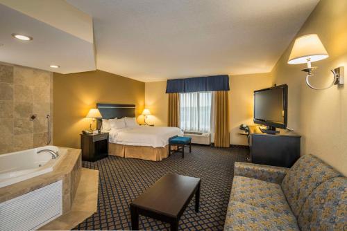 a hotel room with a bed and a television at Hampton Inn & Suites Jacksonville South - Bartram Park in Jacksonville