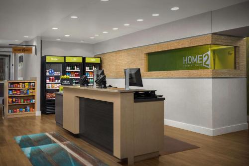a store lobby with a desk with a computer on it at Home2 Suites by Hilton Jacksonville, NC in Jacksonville