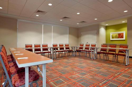 a conference room with tables and chairs in it at Home2 Suites by Hilton Jacksonville, NC in Jacksonville