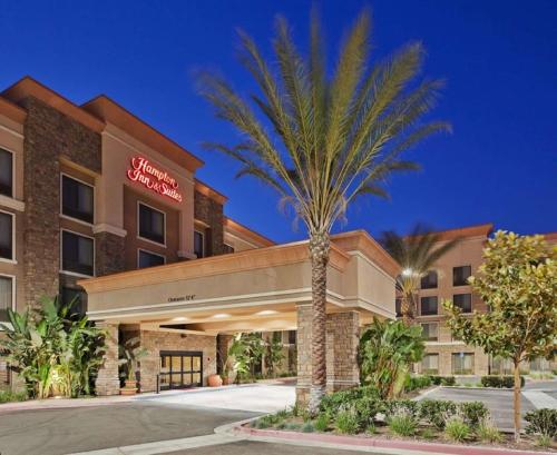 a palm tree in front of a hotel at Hampton Inn & Suites Moreno Valley in Moreno Valley