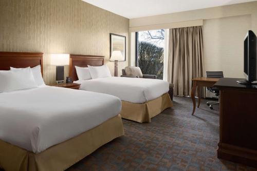 a hotel room with two beds and a television at DoubleTree by Hilton Hotel & Executive Meeting Center Somerset in Somerset