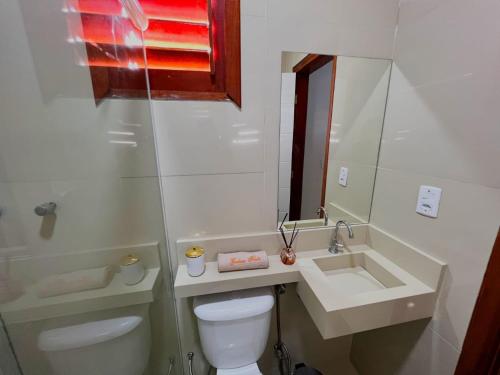 a bathroom with a toilet and a sink at pousada Gostoso Paradise in São Miguel do Gostoso