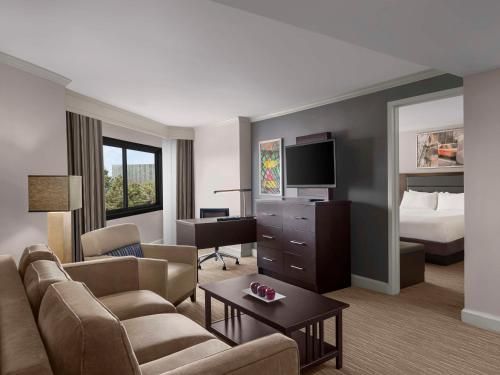 a hotel room with a couch and a bed at DoubleTree by Hilton Fort Lee/George Washington Bridge in Fort Lee
