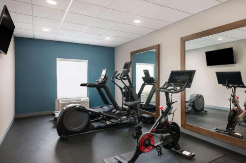 a gym with exercise bikes and a mirror at Hampton Inn & Suites Fort Myers Beach/Sanibel Gateway in Fort Myers Beach