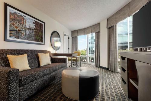 a living room with a couch and a table at Hampton Inn & Suites Greenville-Downtown-Riverplace in Greenville