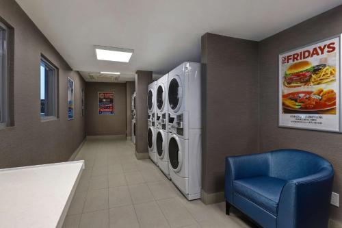 a hospital hallway with washing machines and a blue chair at Embassy Suites by Hilton Niagara Falls/ Fallsview in Niagara Falls